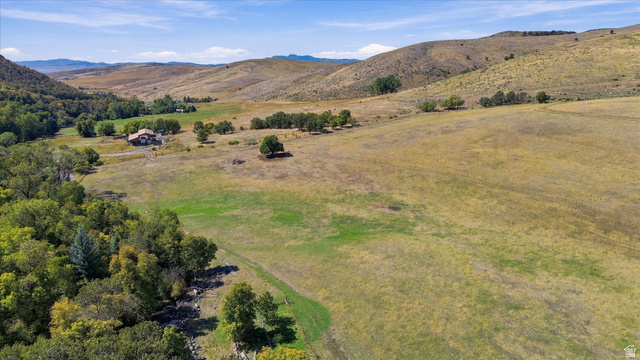 2705 East Canyon Road Smithfield, UT 84335 - Photo 8 of 13 Expansive natural landscape with rolling hills, mature trees, and a distant residence