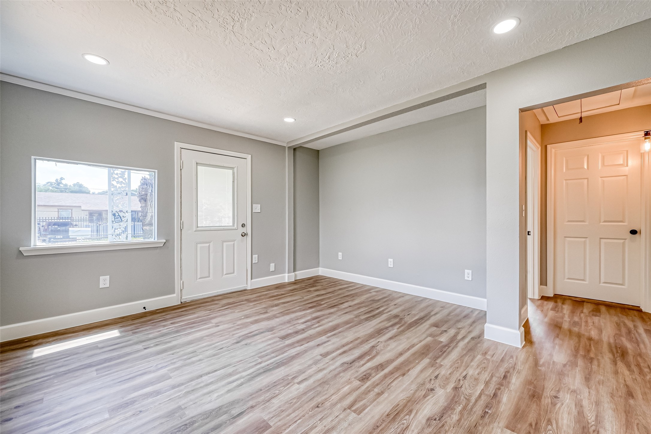 6715 Victoria Street Houston, TX 77020 - Photo 8 of 46 a view of an empty room with wooden floor and a window