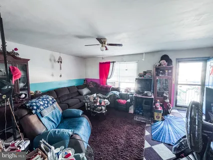 a living room with furniture chess board and a window