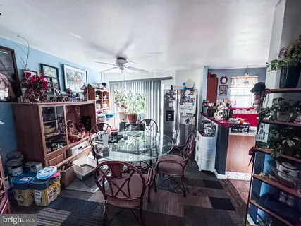 a view of a dining room with furniture cabinet and window