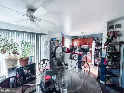 a view of a dining room with furniture chandelier and window