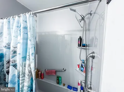 a bathroom with a shower and a shower curtain