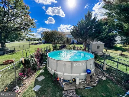 a view of a small house with a swimming pool