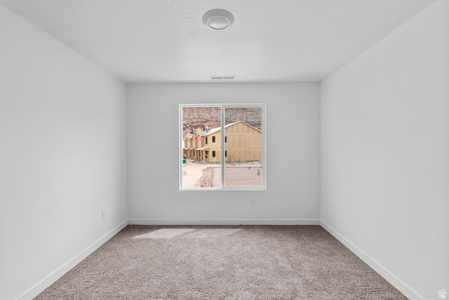 2133 Wolverine Way, Unit 2440 Washington, UT 84780 - Photo 18 of 39 Spacious room with plush carpeting, crisp white walls, and a recessed ceiling light