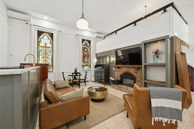 a living room with furniture a fireplace and a flat screen tv