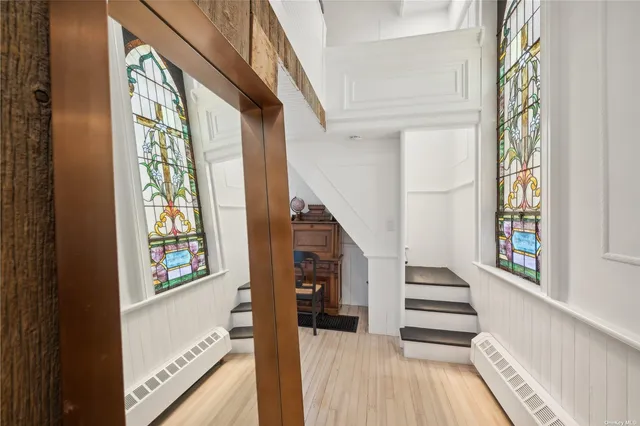 a view of an entryway with wooden floor and windows