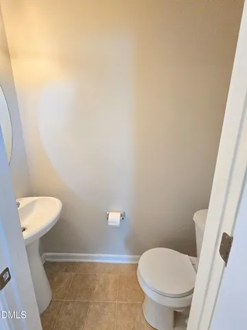 a white toilet sitting next to a white cabinet