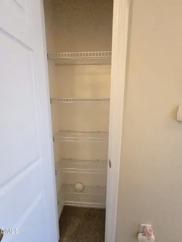 an empty room with windows and ceiling fan