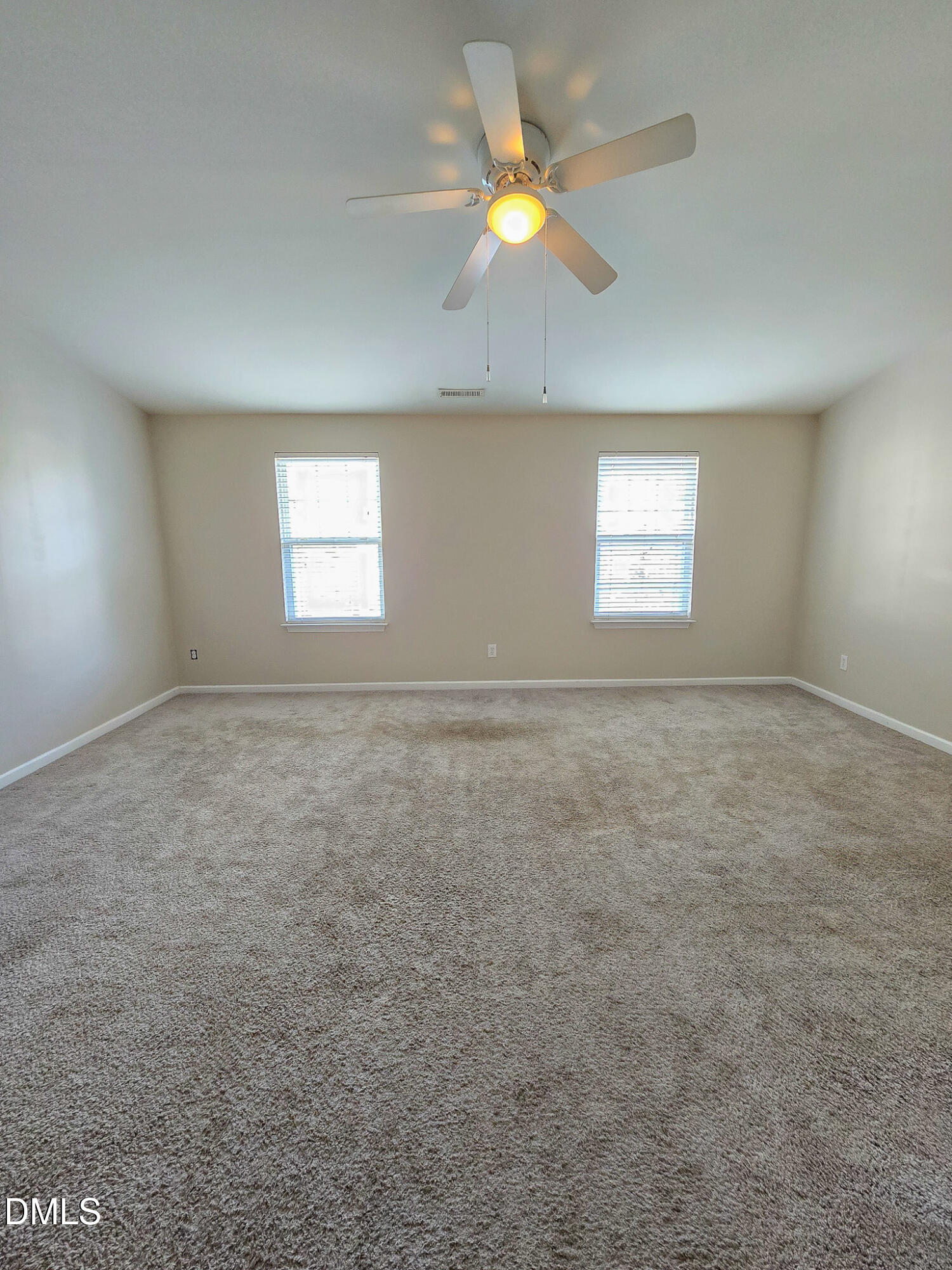 8641 Neuse Club Lane Raleigh, NC 27616 - Photo 27 of 35 an empty room with windows and ceiling fan