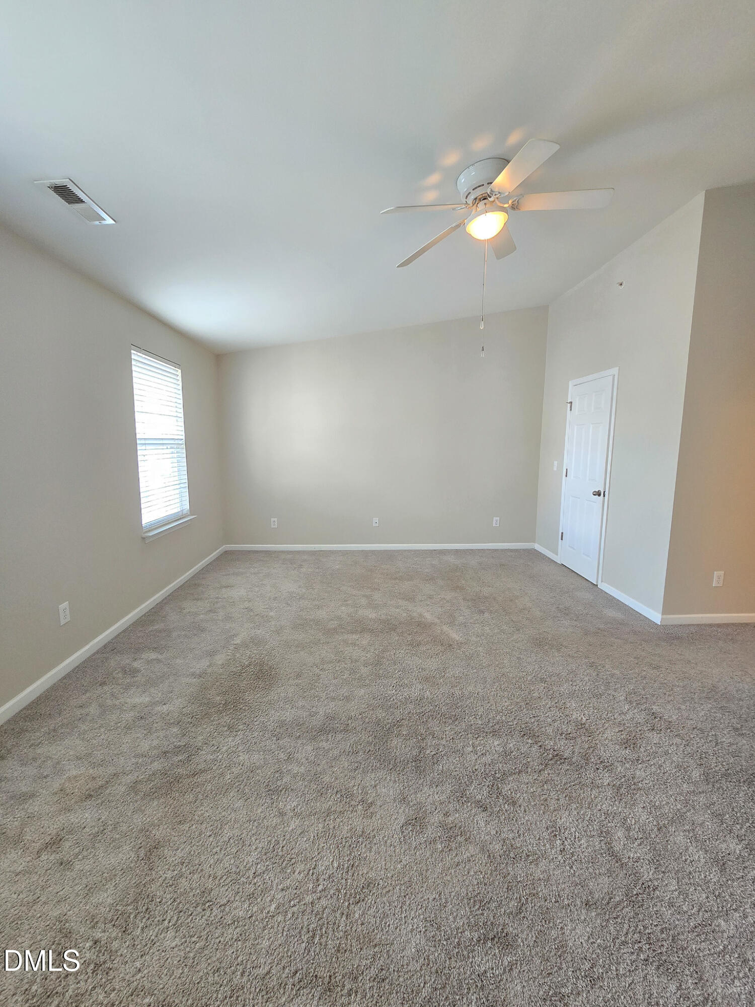8641 Neuse Club Lane Raleigh, NC 27616 - Photo 28 of 35 an empty room with windows and fan