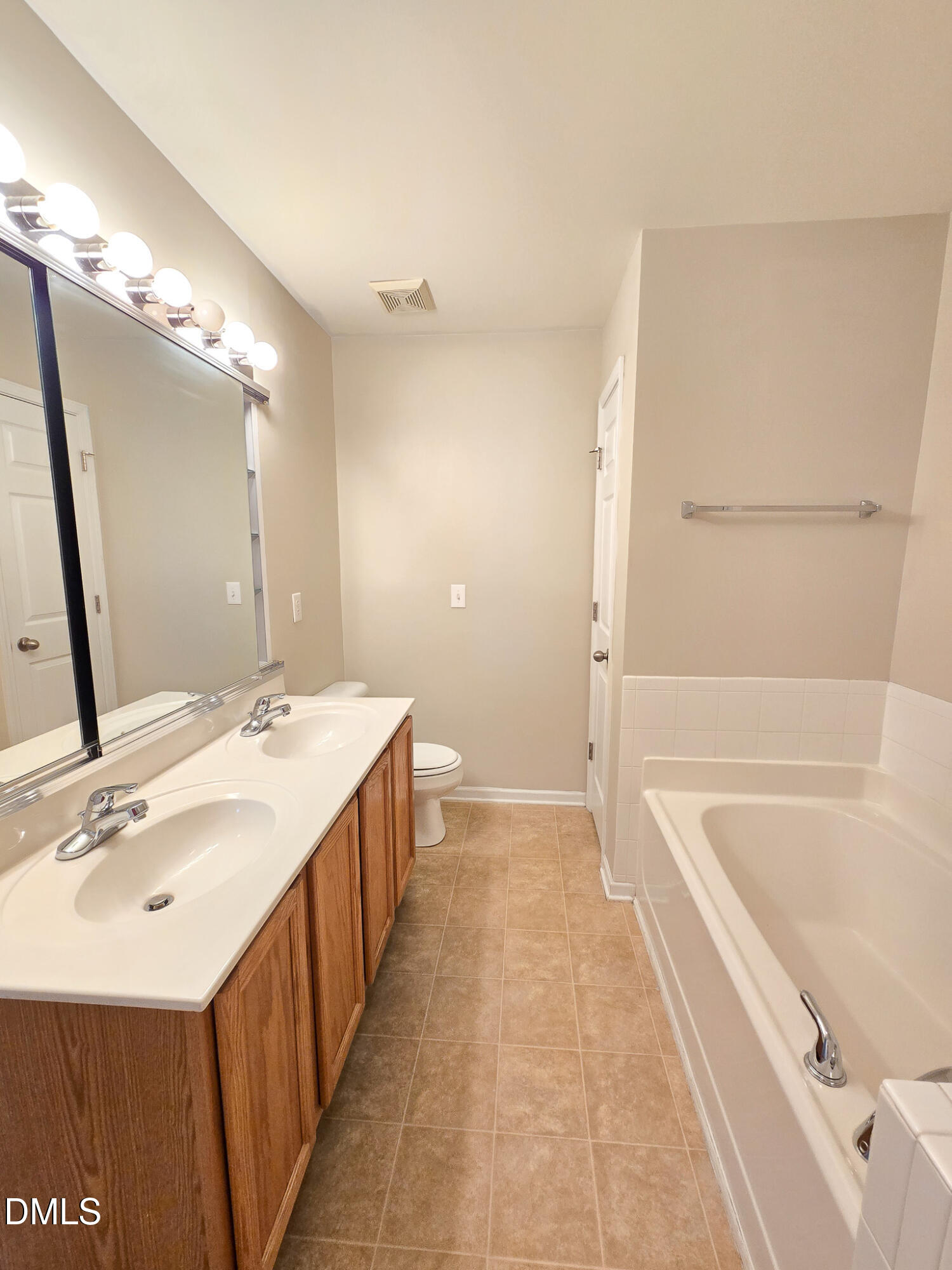 8641 Neuse Club Lane Raleigh, NC 27616 - Photo 33 of 35 a spacious bathroom with a tub sink and mirror