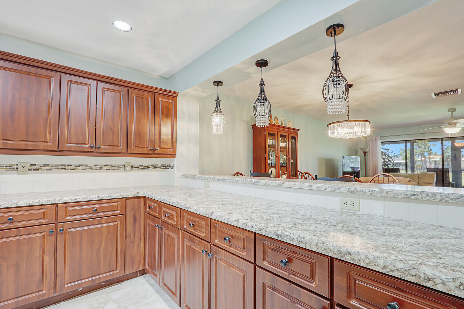 6148 Southeast Georgetown Place, Unit 805 Hobe Sound, FL 33455 - Photo 11 of 44 a kitchen with a sink and cabinets