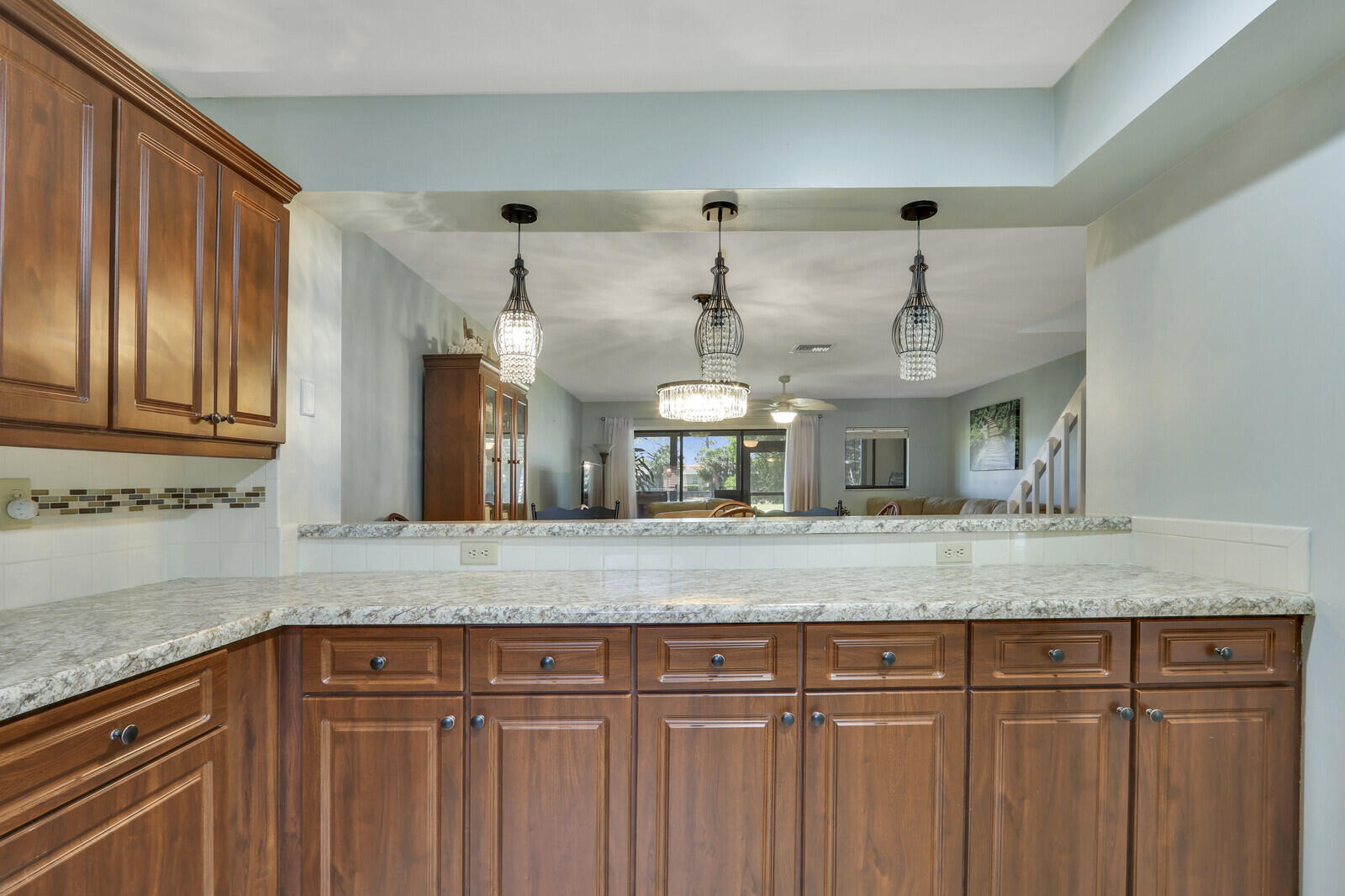 6148 Southeast Georgetown Place, Unit 805 Hobe Sound, FL 33455 - Photo 16 of 44 a view of a kitchen counter space with granite countertop cabinets