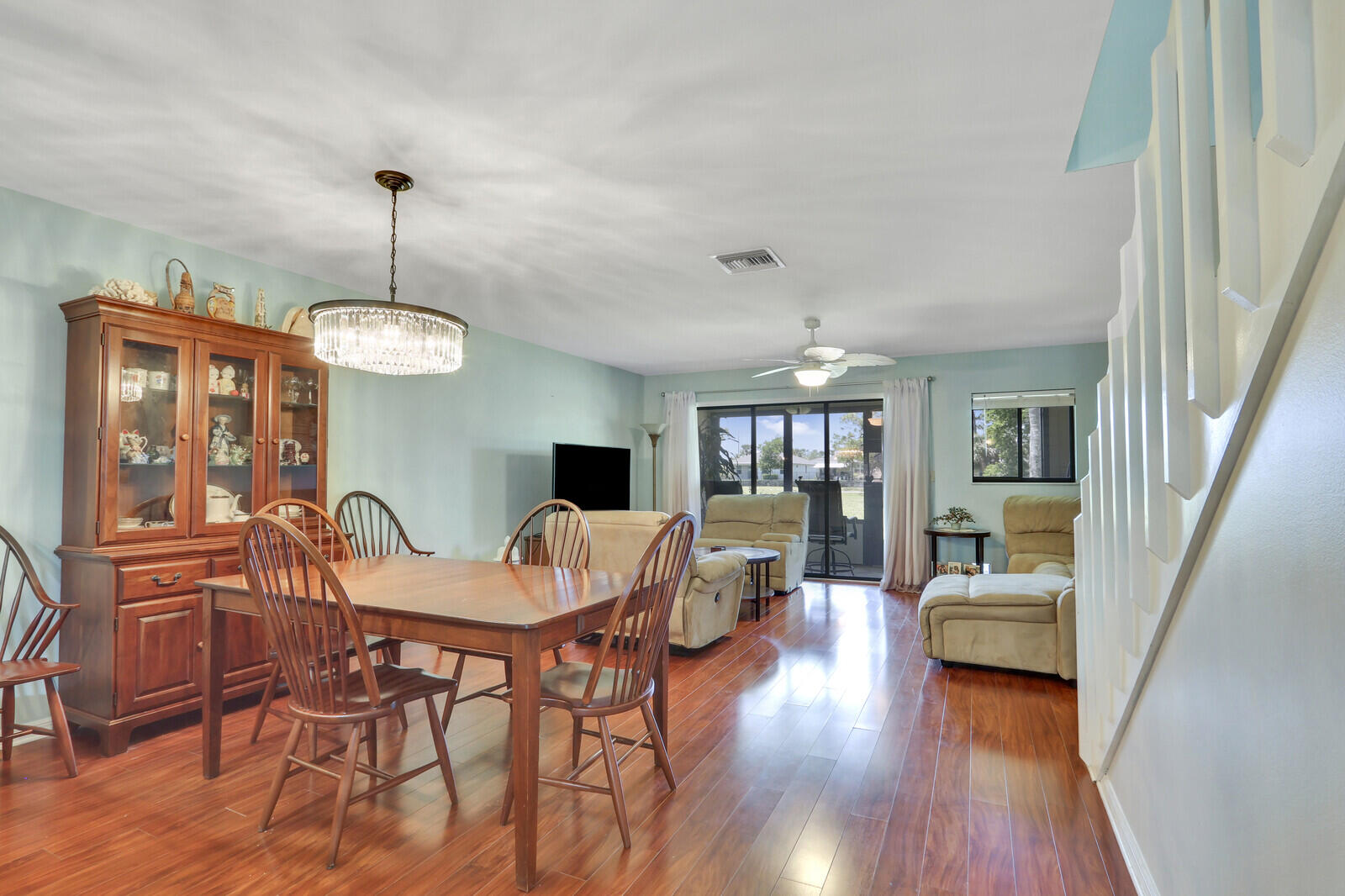 6148 Southeast Georgetown Place, Unit 805 Hobe Sound, FL 33455 - Photo 17 of 44 a view of a dining room with furniture window and wooden floor