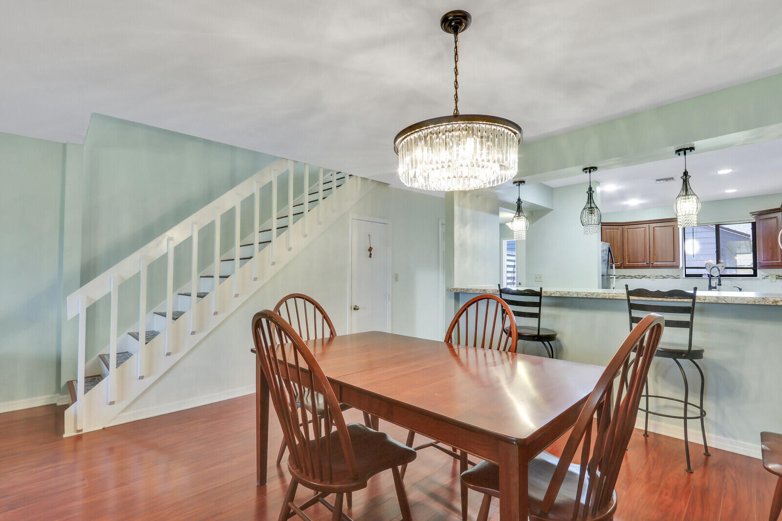 6148 Southeast Georgetown Place, Unit 805 Hobe Sound, FL 33455 - Photo 20 of 44 a view of a dining room with furniture and wooden floor