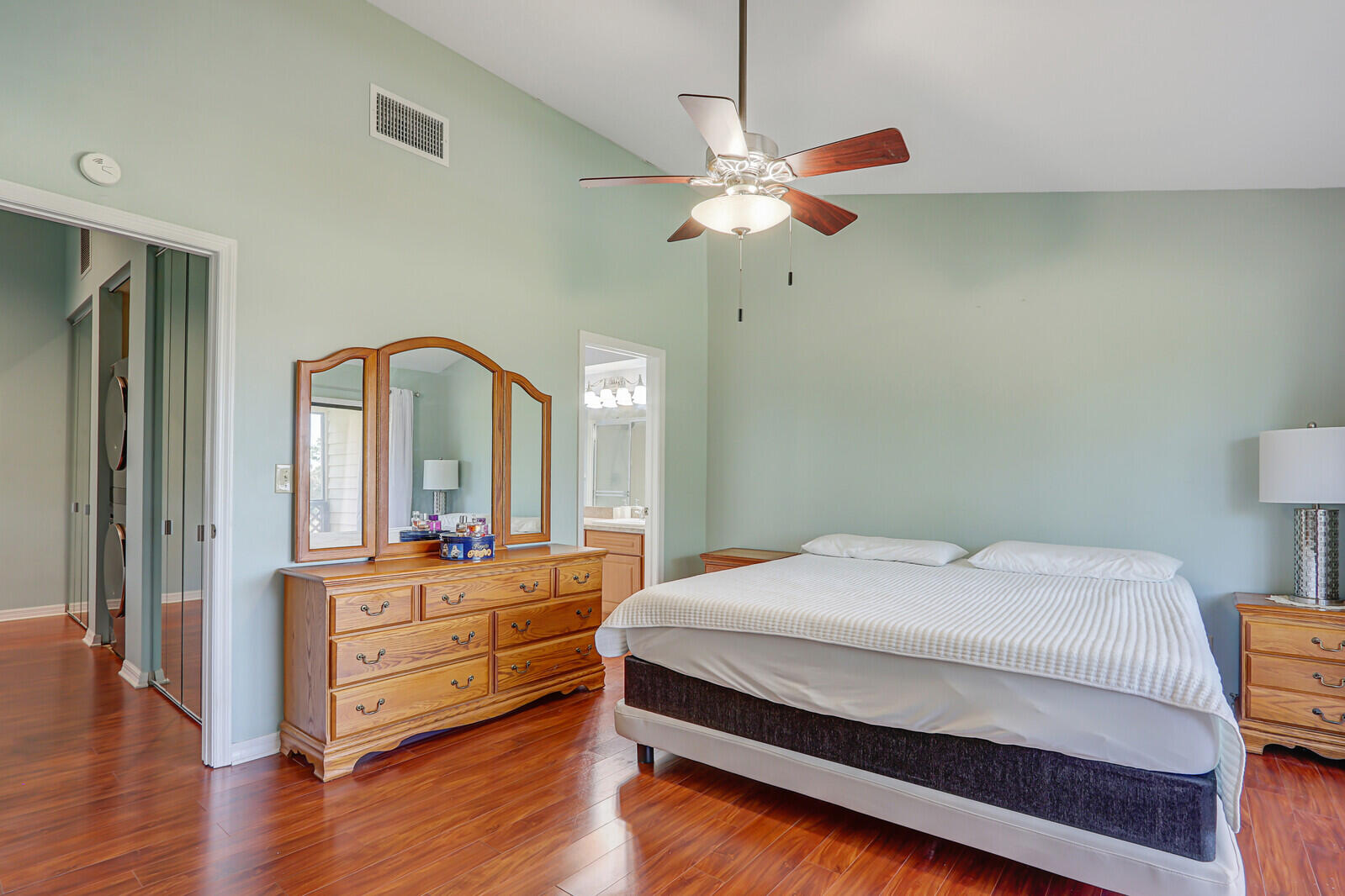 6148 Southeast Georgetown Place, Unit 805 Hobe Sound, FL 33455 - Photo 27 of 44 a bedroom with a bed and a chandelier