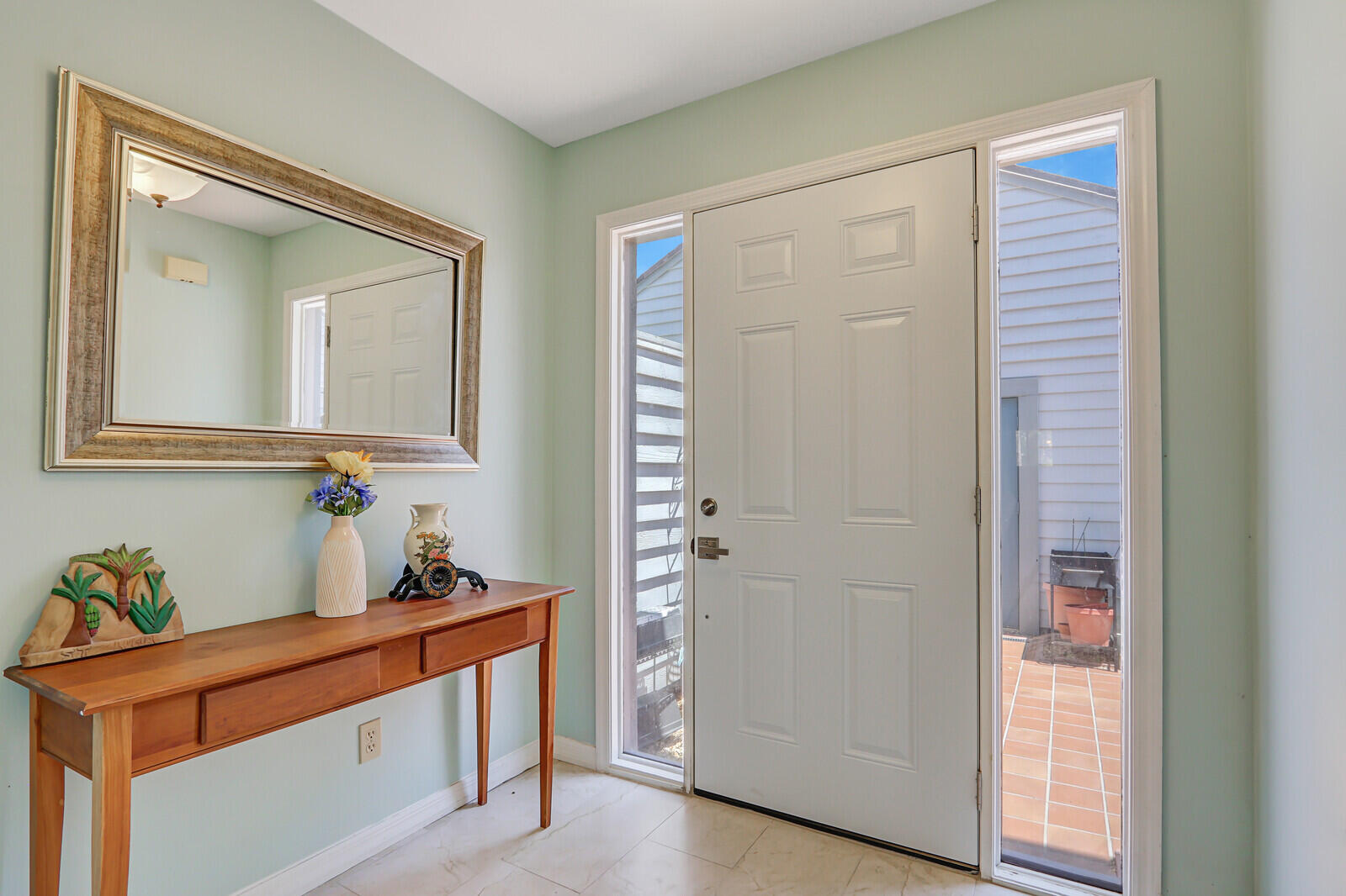 6148 Southeast Georgetown Place, Unit 805 Hobe Sound, FL 33455 - Photo 8 of 44 a room that has a mirror and a sink in it