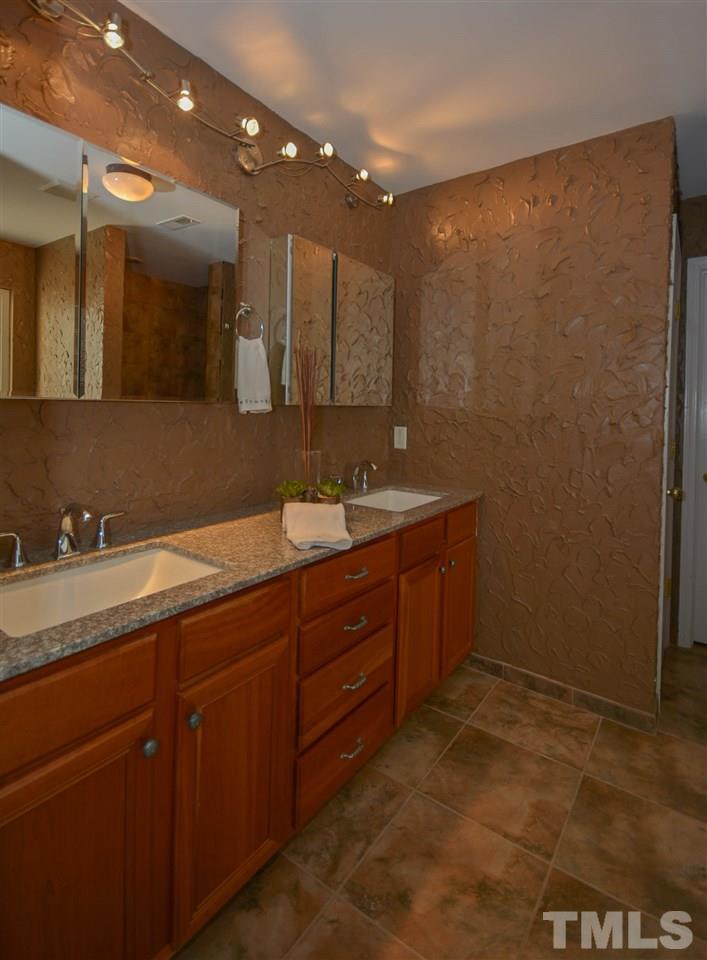 8502 Pillar Gate Lane Raleigh, NC 27613 - Photo 13 of 22 a bathroom with a double vanity sink and a mirror