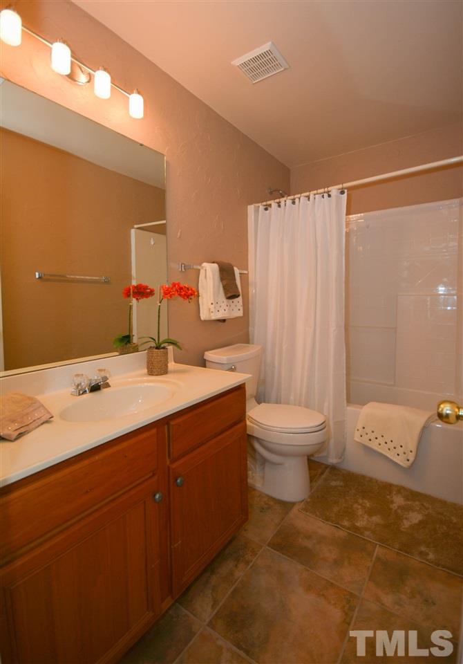 8502 Pillar Gate Lane Raleigh, NC 27613 - Photo 19 of 22 a bathroom with a sink toilet and shower