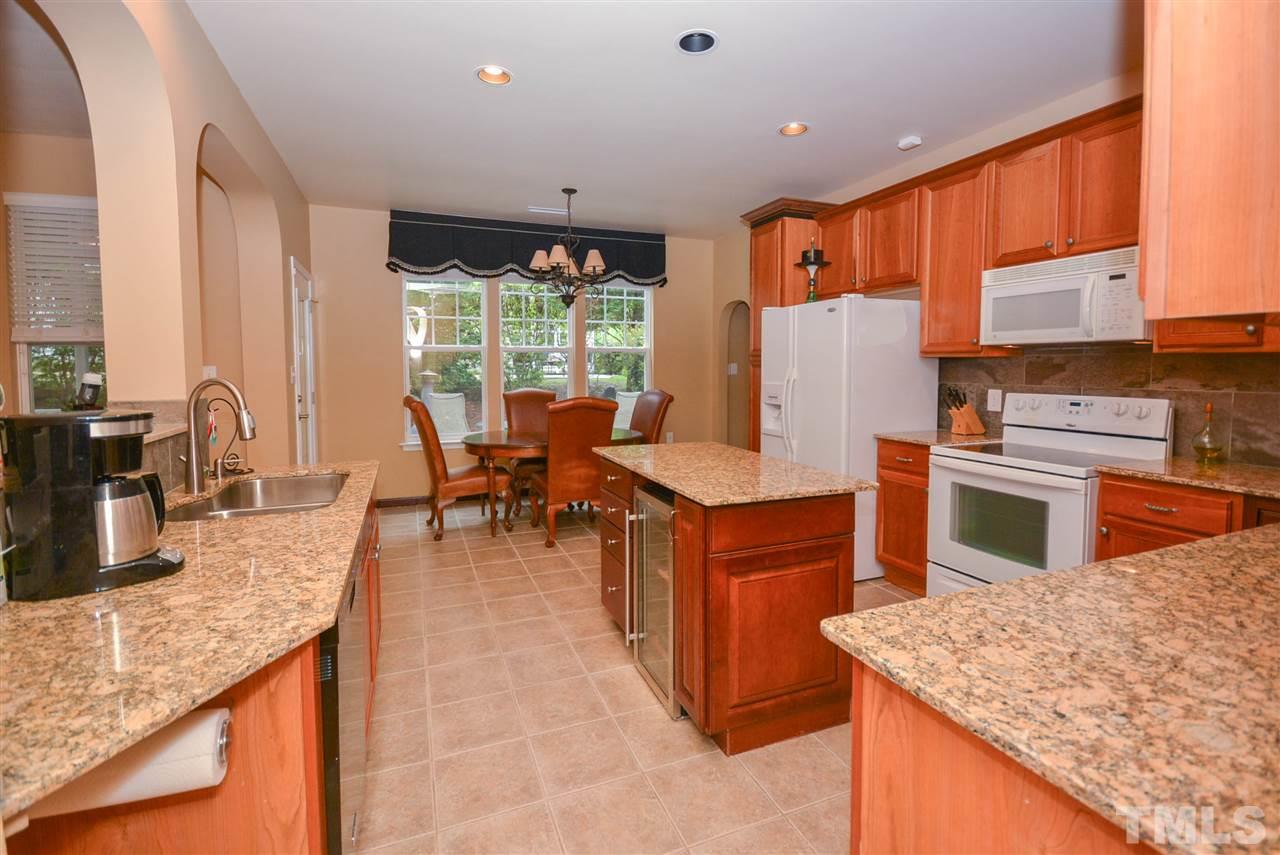 8502 Pillar Gate Lane Raleigh, NC 27613 - Photo 5 of 22 a kitchen with stainless steel appliances granite countertop sink stove top oven and cabinets