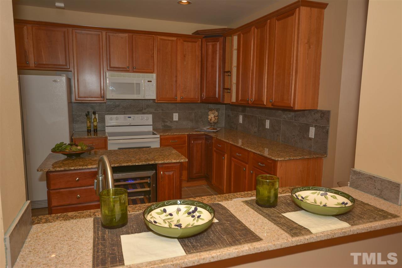 8502 Pillar Gate Lane Raleigh, NC 27613 - Photo 6 of 22 a kitchen with a table and chairs in it