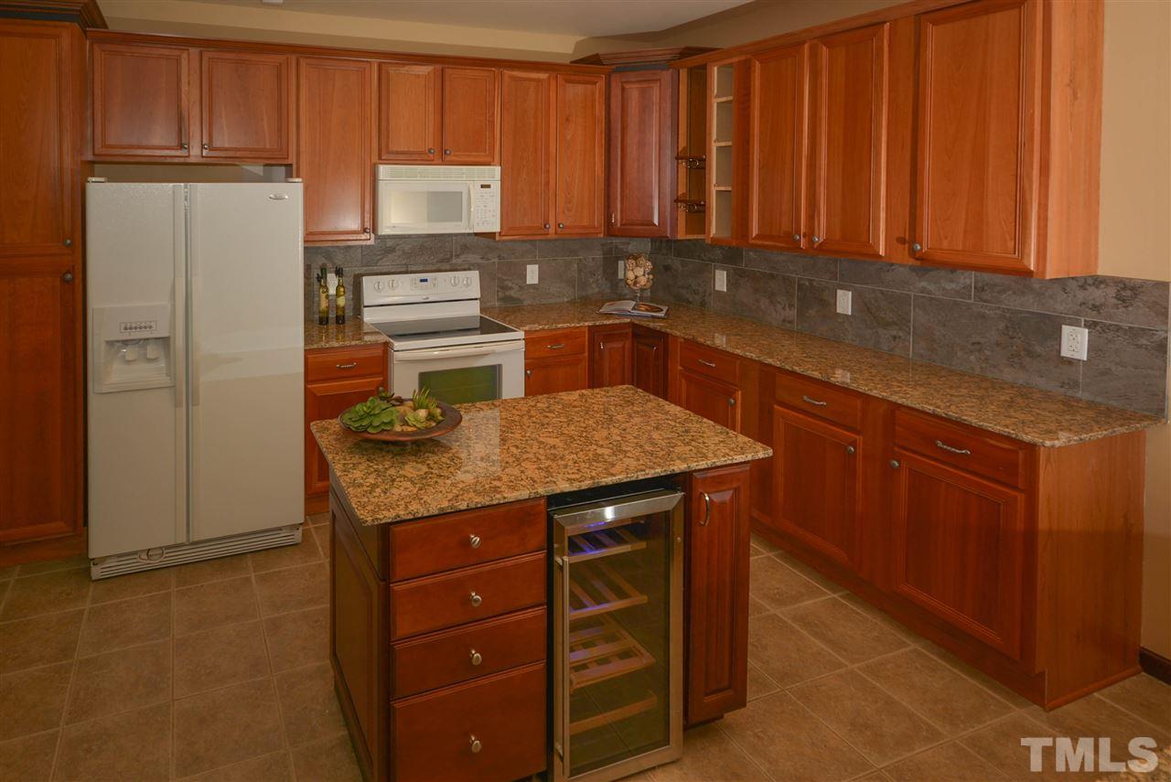 8502 Pillar Gate Lane Raleigh, NC 27613 - Photo 7 of 22 a kitchen with stainless steel appliances granite countertop wooden cabinets a refrigerator and dishwasher