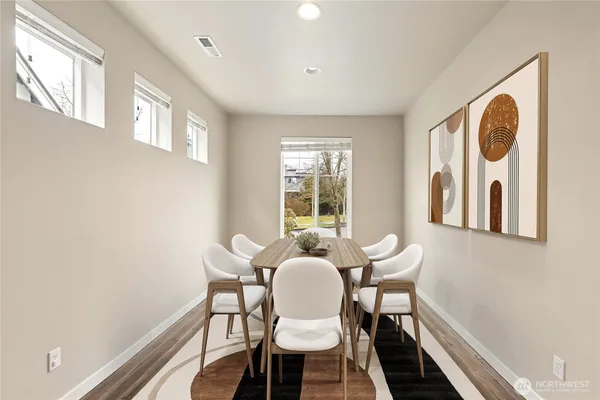 a dining room with furniture and window