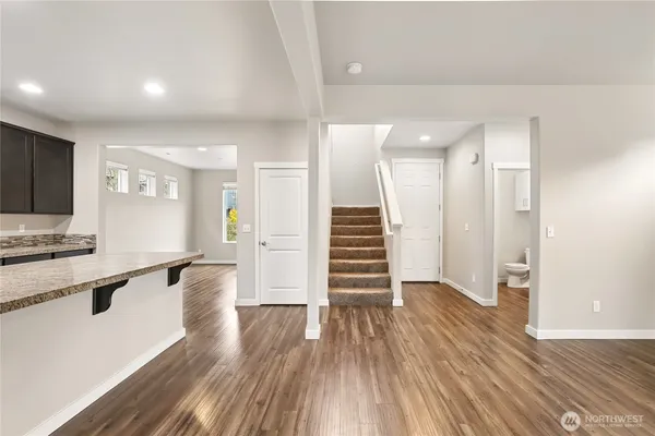 a view of a kitchen with wooden floor and a sink
