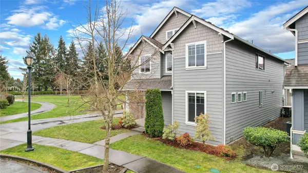 a view of a house with a yard and sitting area
