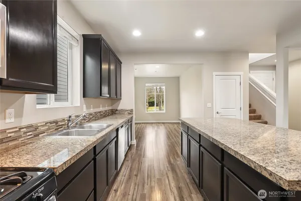 a bathroom with granite countertop double vanity and a sink