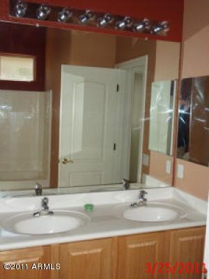 2018 North Pacey Road Phoenix, AZ 85037 - Photo 33 of 35 a bathroom with a sink and a mirror