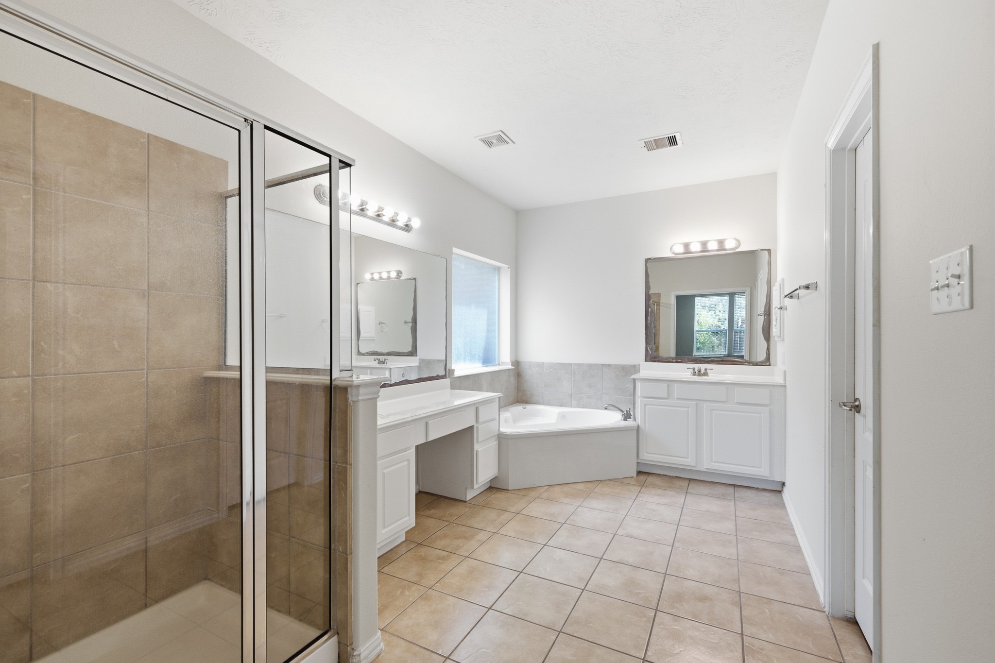 2117 Rushing Spring Drive Pearland, TX 77584 - Photo 23 of 42 Experience luxury in the spacious primary bathroom, featuring a sleek glass-enclosed shower, a relaxing soaking tub, and dual vanities for ultimate convenience.