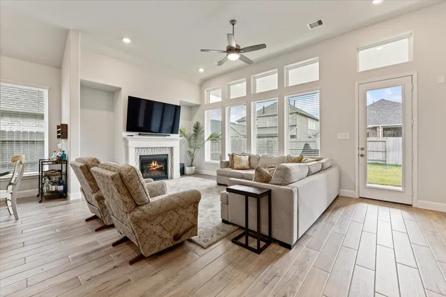 a living room with furniture fireplace and flat screen tv