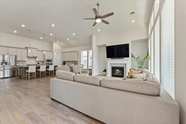 a living room with furniture a fireplace and a flat screen tv
