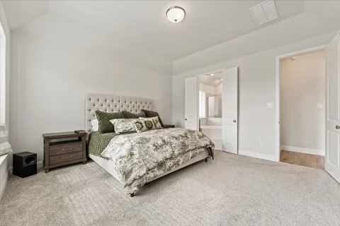 a bedroom with a bed and a night stand