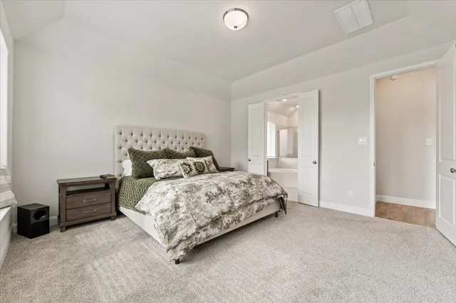 a bedroom with a bed and a night stand