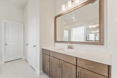 a bathroom with a double vanity sink and a mirror