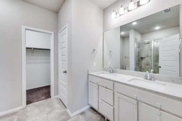 a bathroom with 2 sink and a mirror