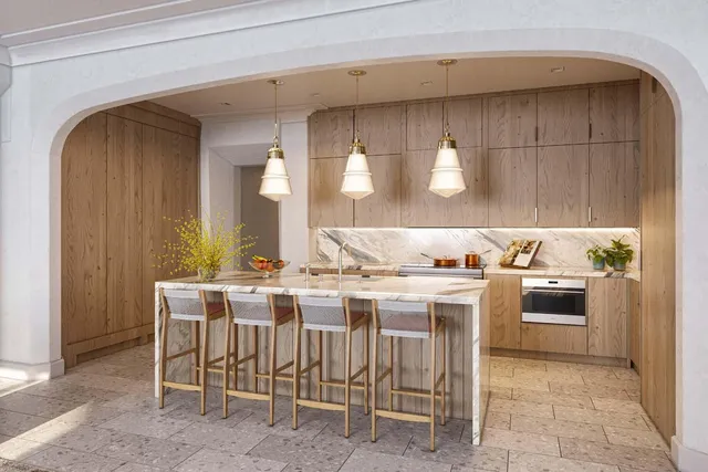 a kitchen with a stove a sink and chairs