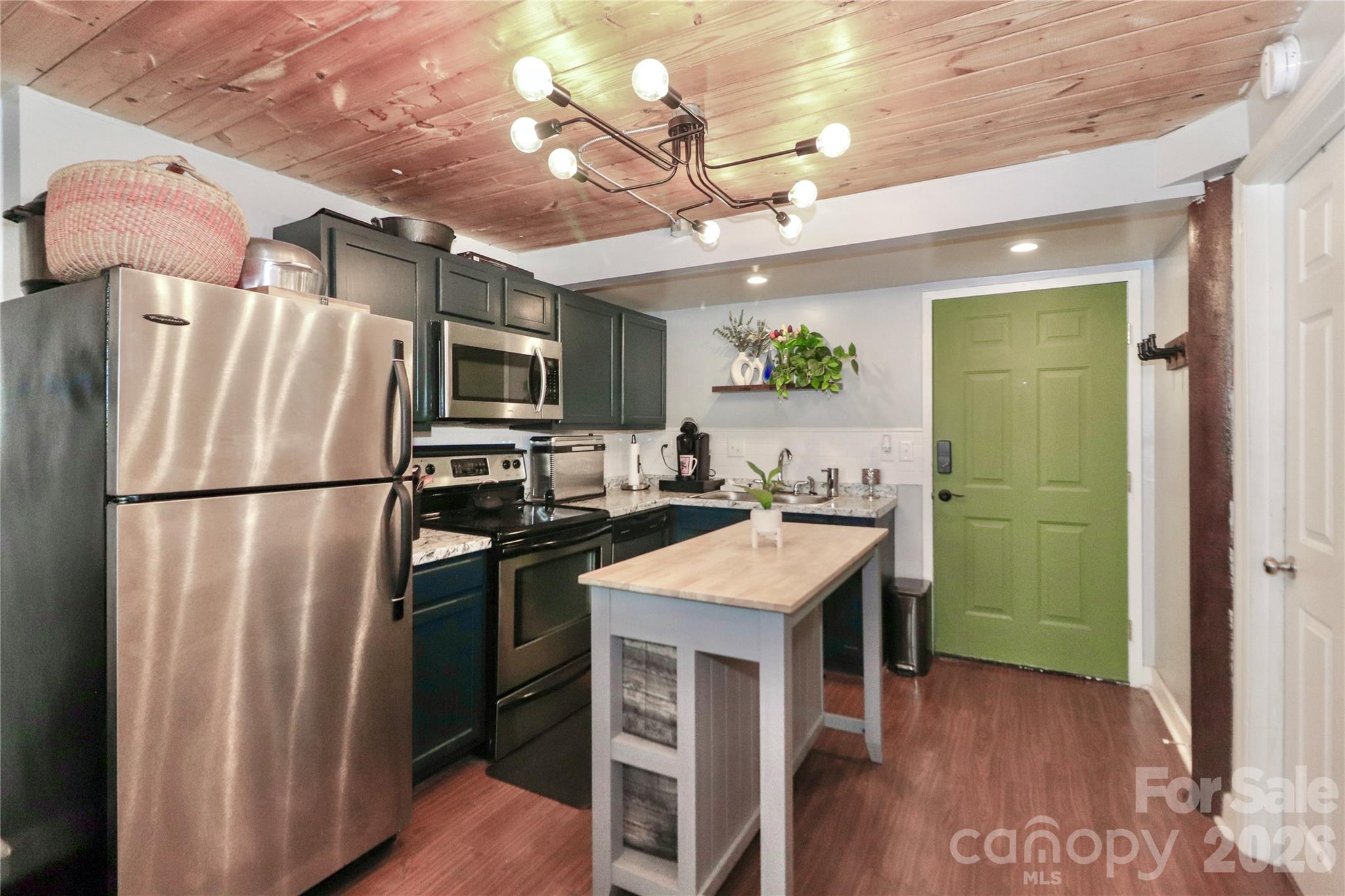 201 South Hoskins Road, Unit 315 Charlotte, NC 28208 - Photo 1 of 45 a kitchen with kitchen island a sink stainless steel appliances and cabinets
