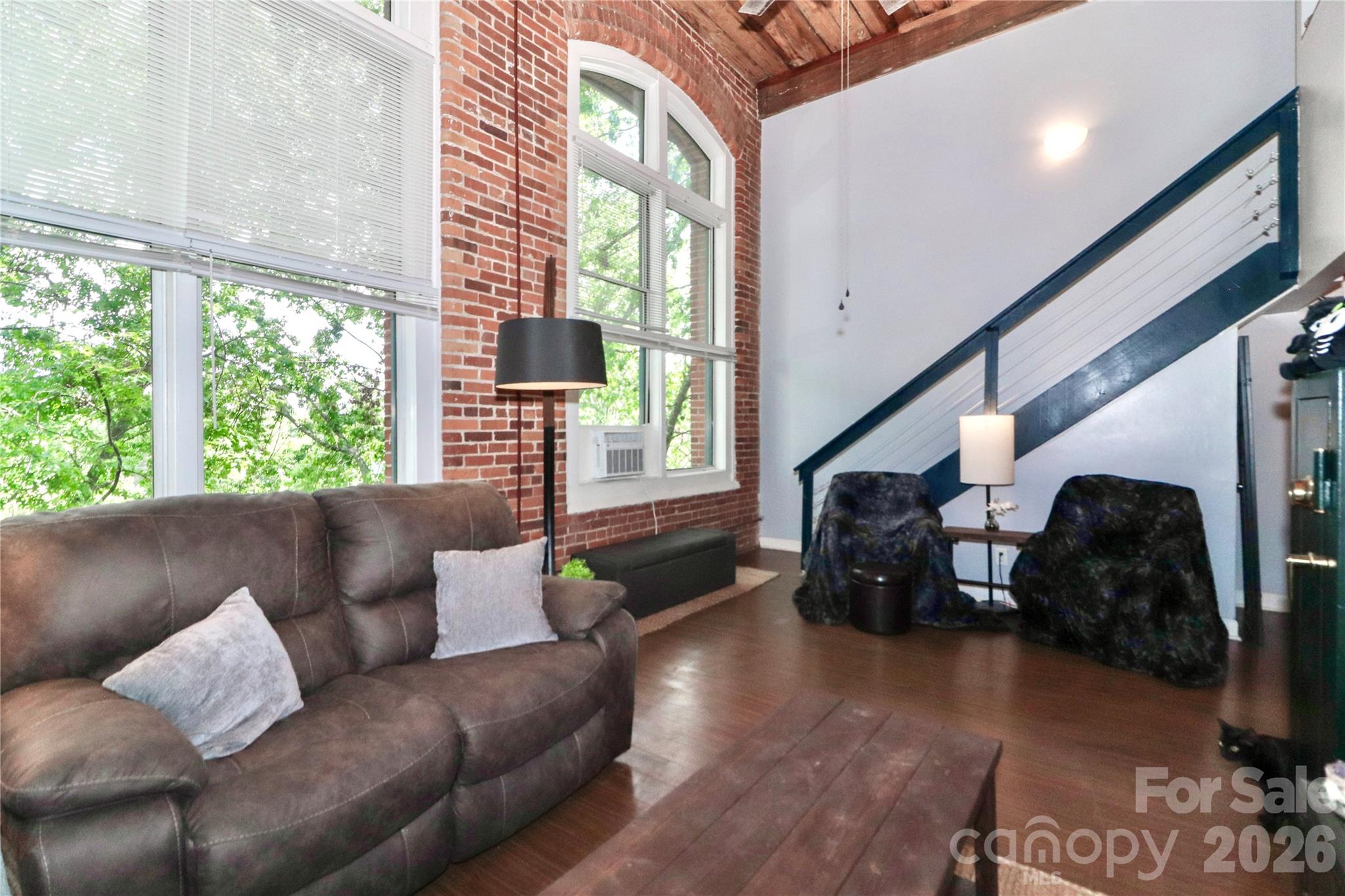 201 South Hoskins Road, Unit 315 Charlotte, NC 28208 - Photo 13 of 45 a living room with furniture and a large window