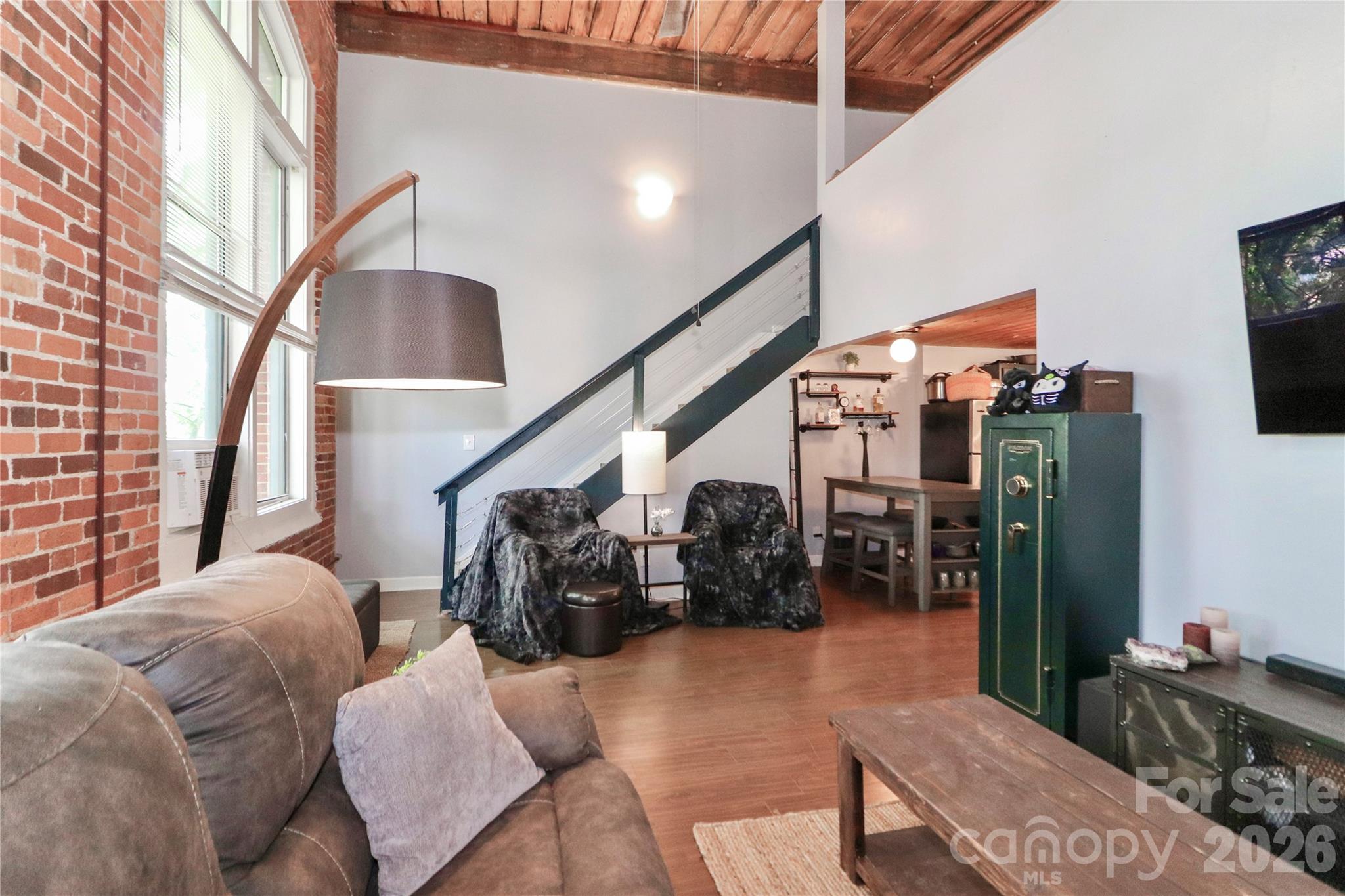 201 South Hoskins Road, Unit 315 Charlotte, NC 28208 - Photo 18 of 45 a living room with furniture and wooden floor