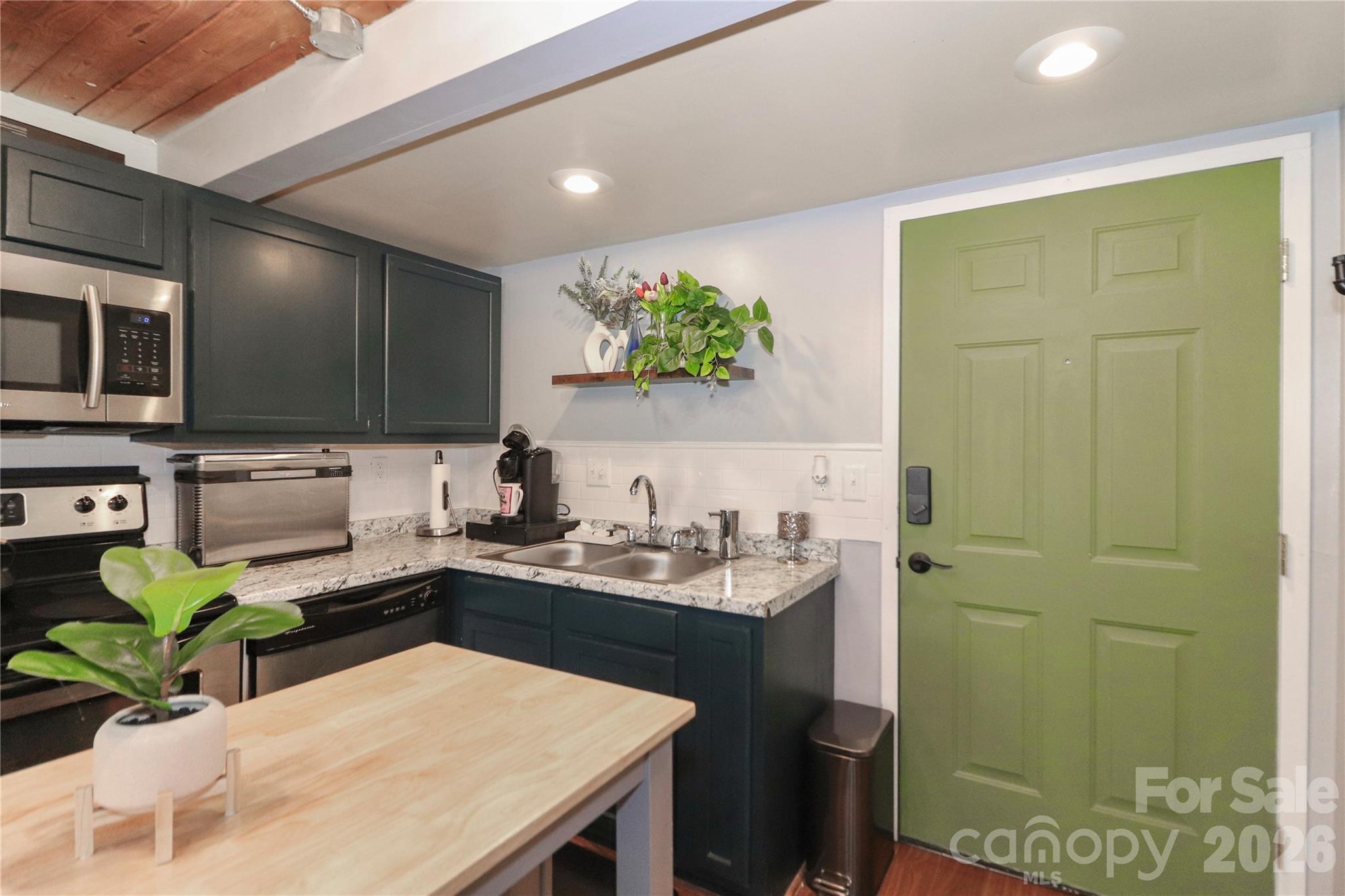 201 South Hoskins Road, Unit 315 Charlotte, NC 28208 - Photo 19 of 40 a kitchen with a sink a counter cabinets and appliances