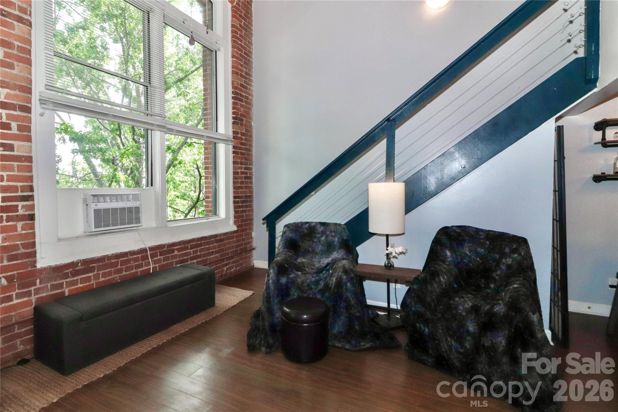 201 South Hoskins Road, Unit 315 Charlotte, NC 28208 - Photo 19 of 45 a living room with furniture and wooden floor