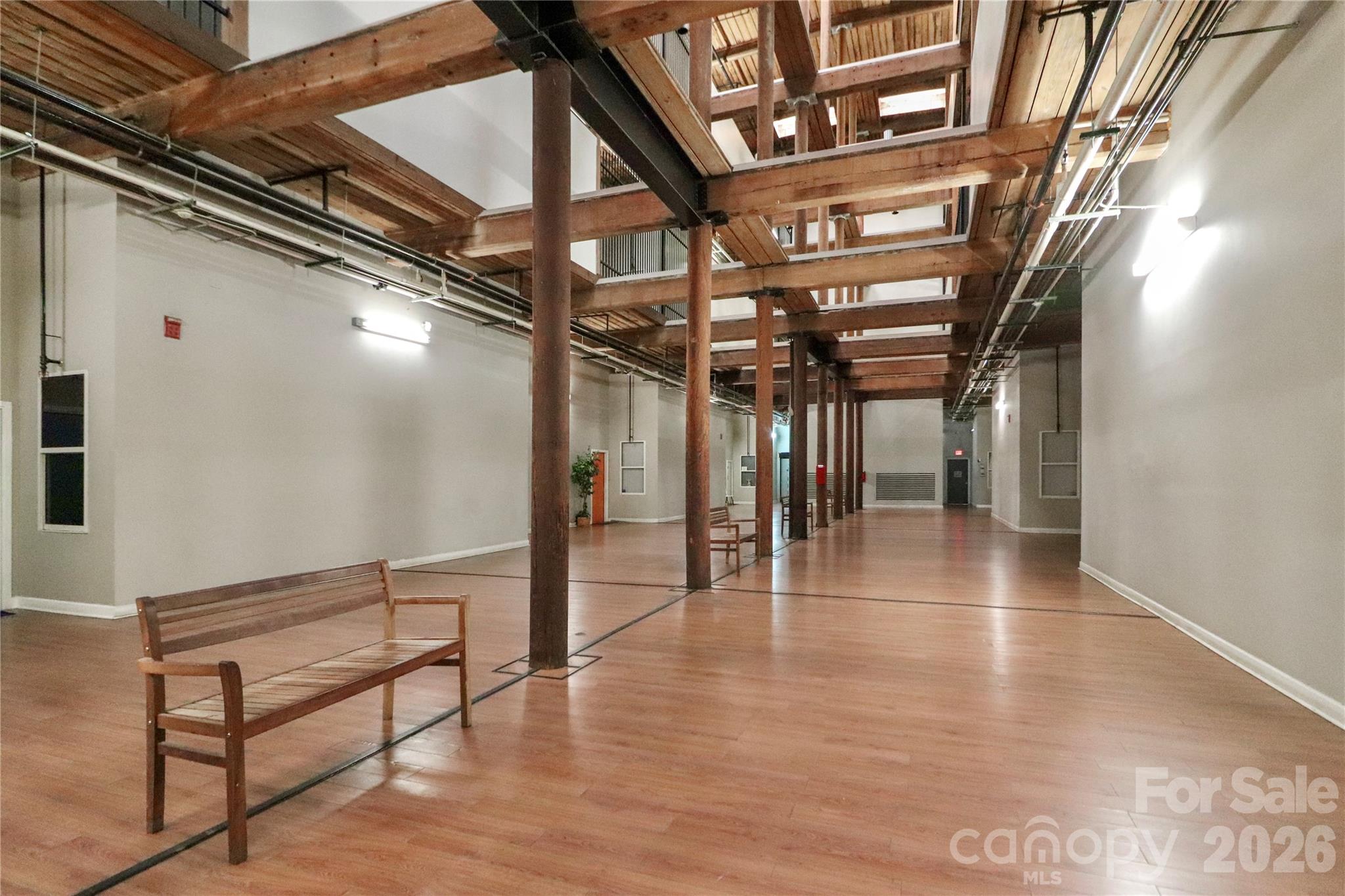 201 South Hoskins Road, Unit 315 Charlotte, NC 28208 - Photo 31 of 45 a view of an empty room with wooden floor