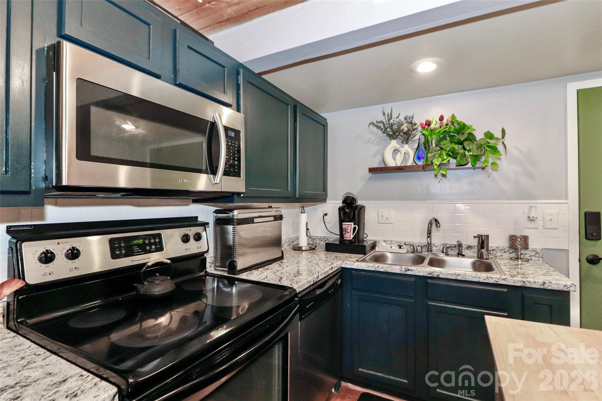 201 South Hoskins Road, Unit 315 Charlotte, NC 28208 - Photo 6 of 45 a kitchen with stainless steel appliances a stove and a microwave