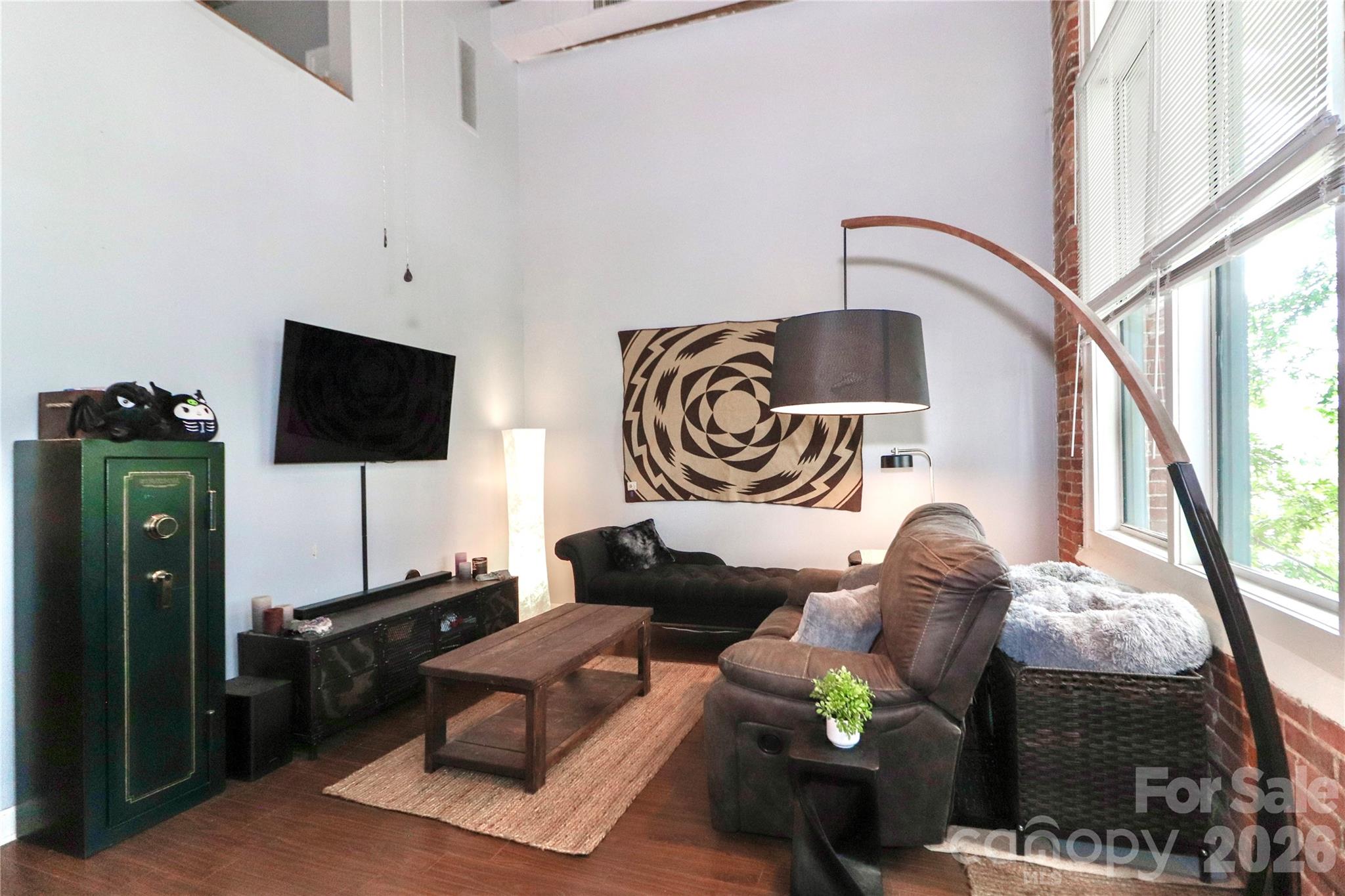 201 South Hoskins Road, Unit 315 Charlotte, NC 28208 - Photo 6 of 40 a living room with furniture and a flat screen tv