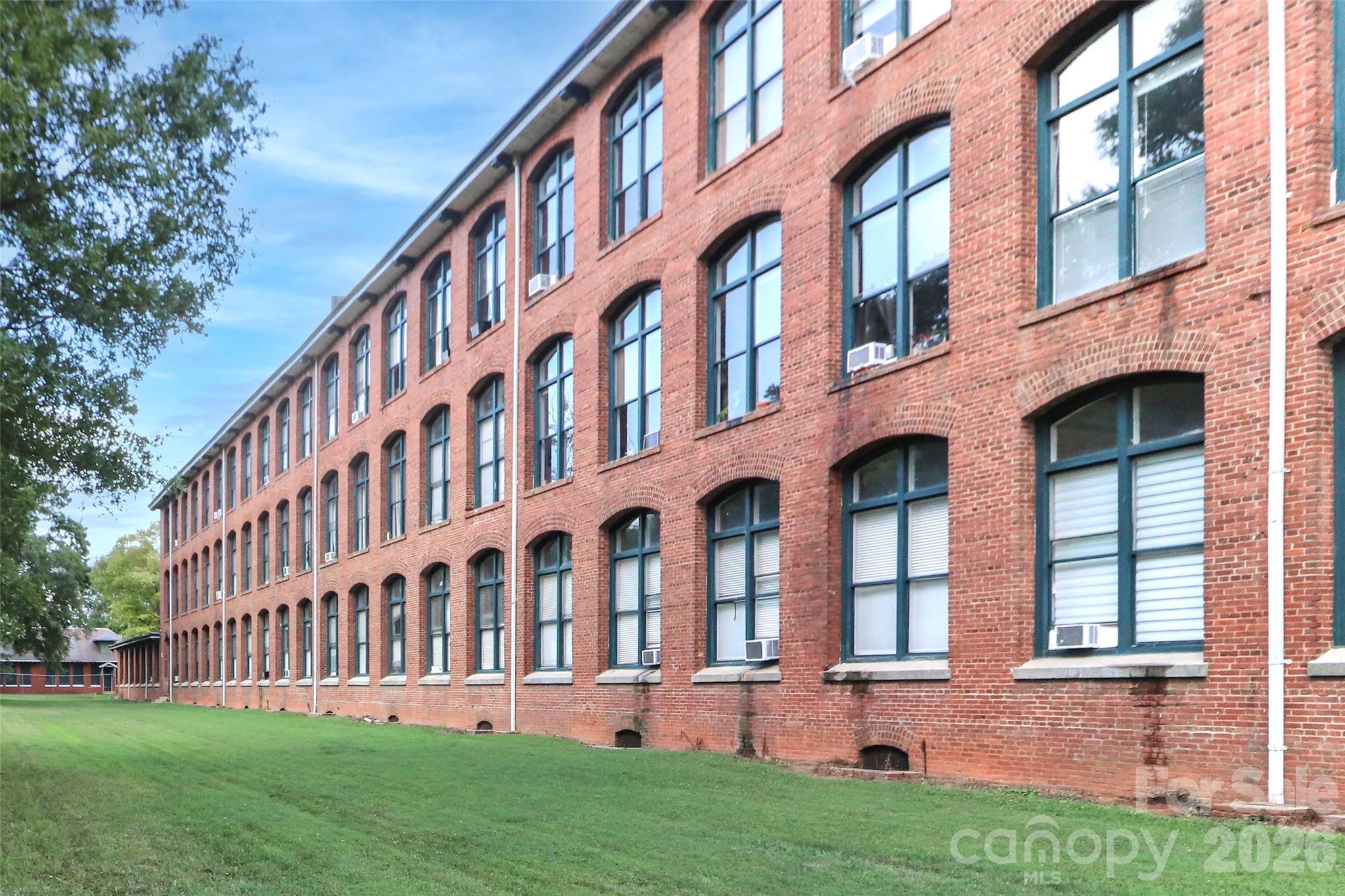 201 South Hoskins Road, Unit 315 Charlotte, NC 28208 - Photo 7 of 45 front view of building with a yard