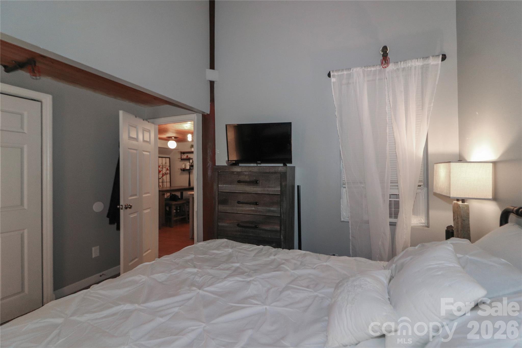 201 South Hoskins Road, Unit 315 Charlotte, NC 28208 - Photo 9 of 40 a bedroom with a bed and a flat screen tv