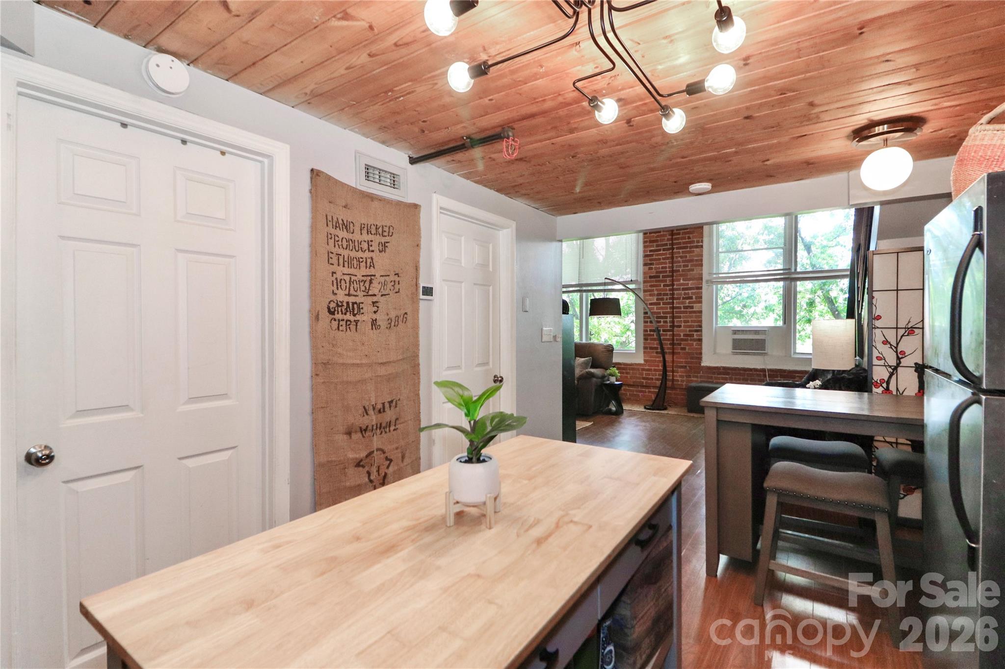 201 South Hoskins Road, Unit 315 Charlotte, NC 28208 - Photo 9 of 45 a kitchen with kitchen island a stove a sink and a refrigerator